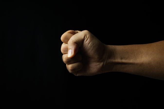 male hand fist on dark background