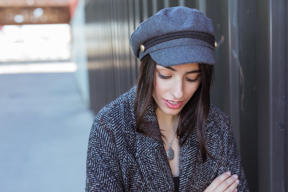 Charming Hispanic woman near wall