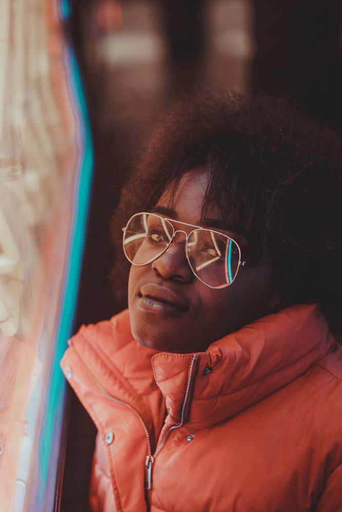 Black woman standing on night city street