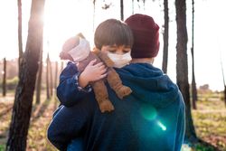 Father holding son in wood