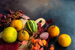 Autumn squash on rustic breadboard and leaves