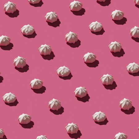 Pattern of meringues on pink background