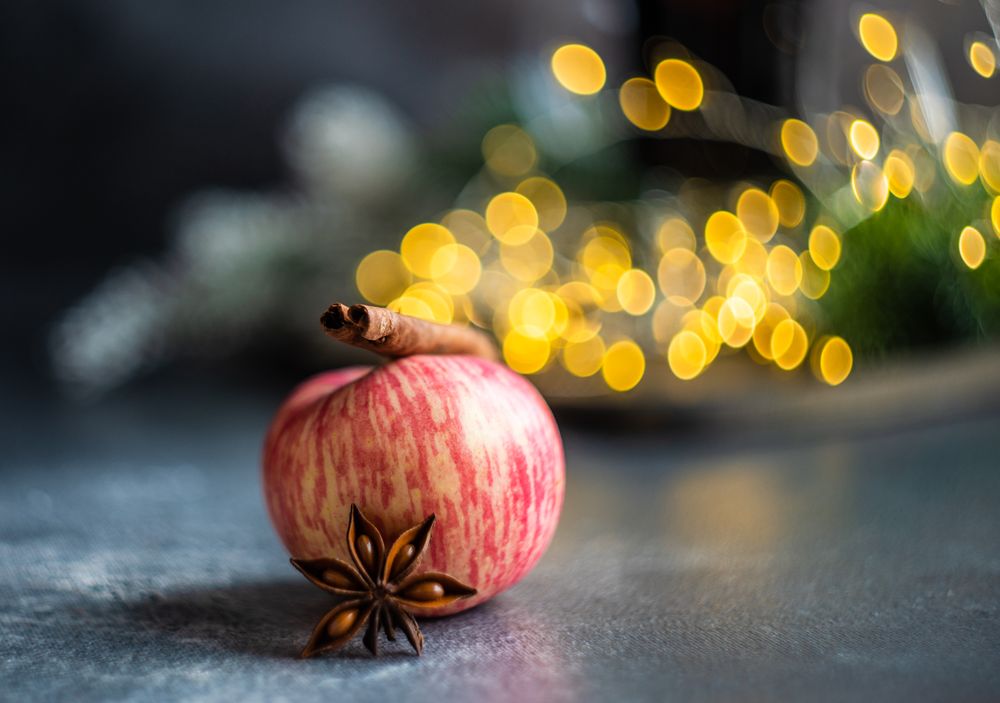 Apple on table with star anise and cinnamon stick