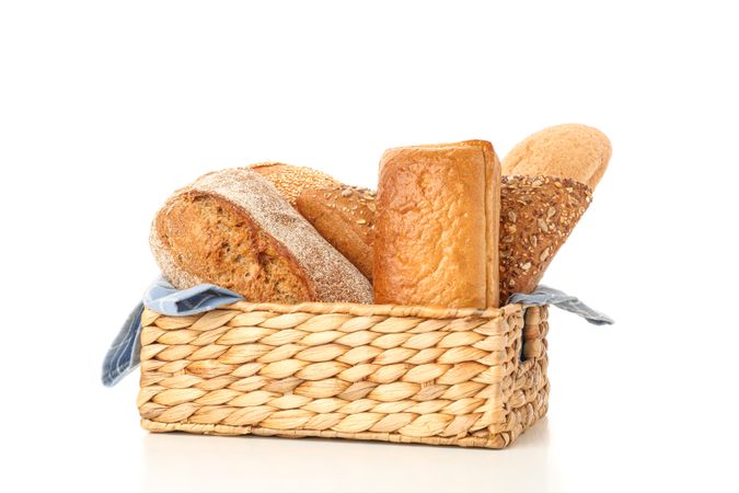 Bakery products in straw basket isolated on blank background