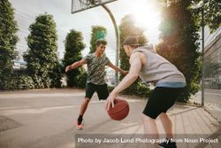 Young friends playing basketball together 0PjMR2