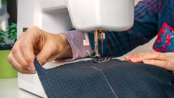 Seamstress hands working on a sewing machine