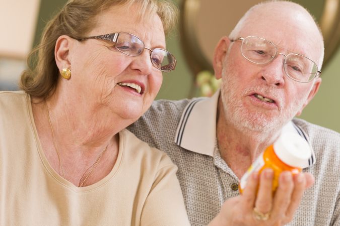 Couple Reading Medicine Bottle