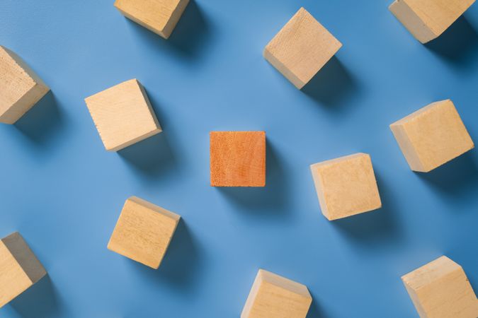 an empty wooden blocks with different color wooden blocks in the center isolated on blue background