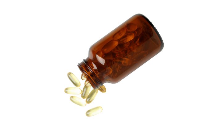 Brown bottle with omega pills, isolated on blank background