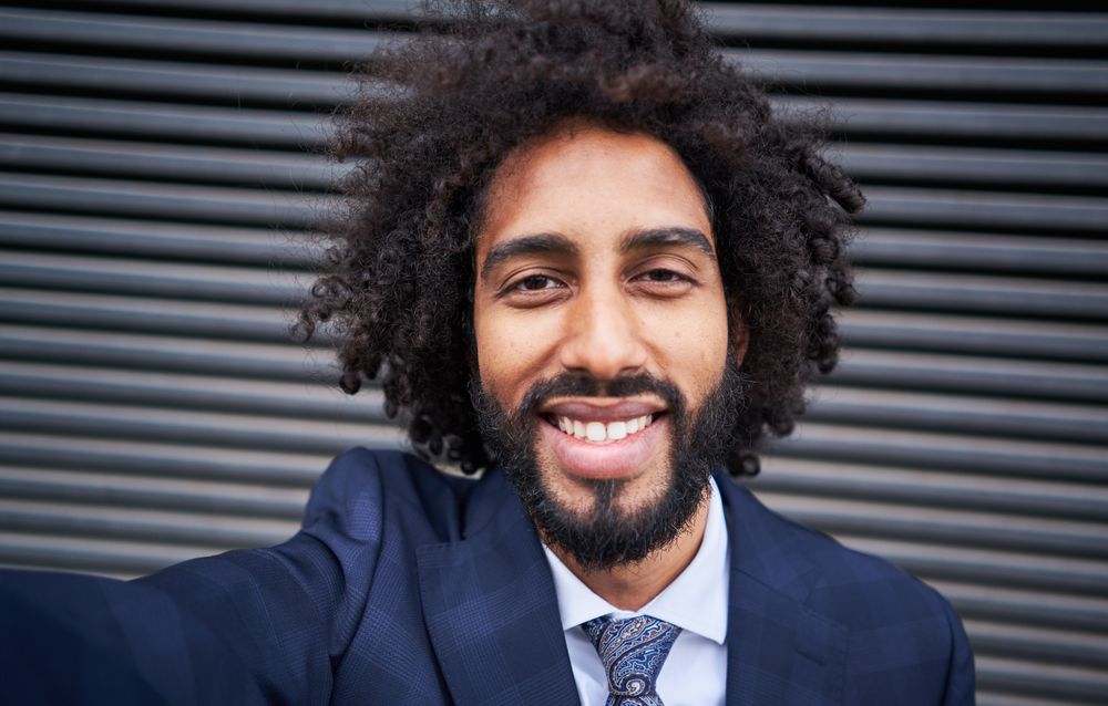 Joyful man taking selfie and smiling