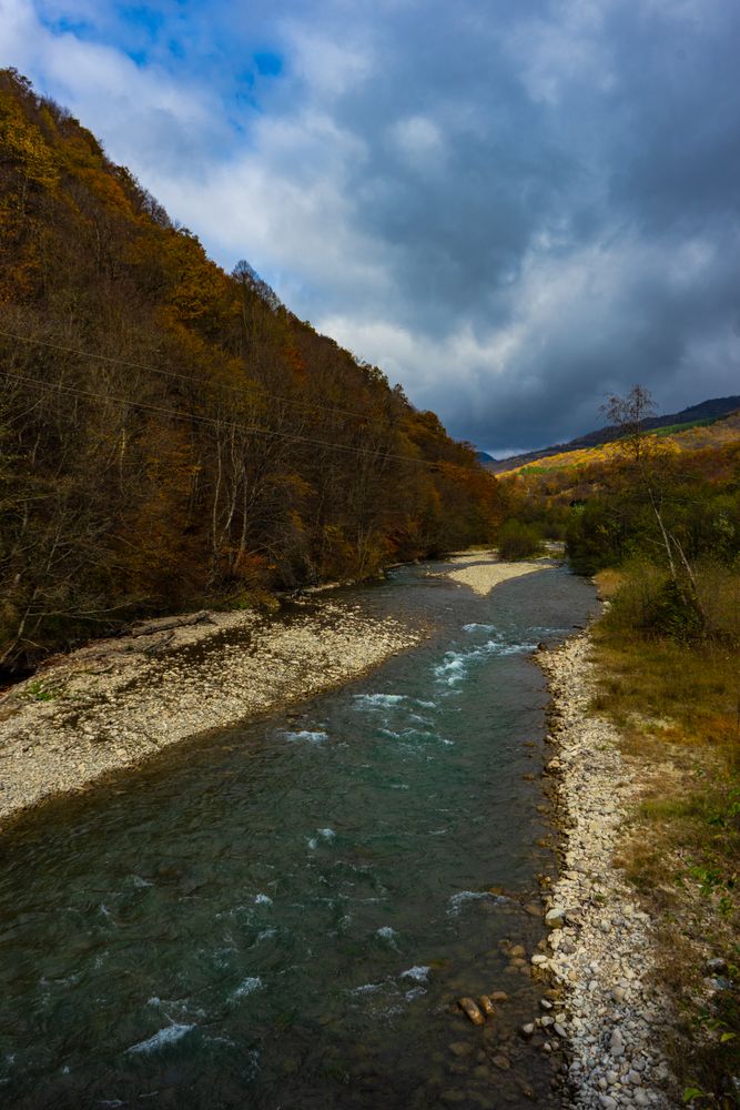 Lori river and mountain slopes with covered yellow leaves trees close to Bochorma