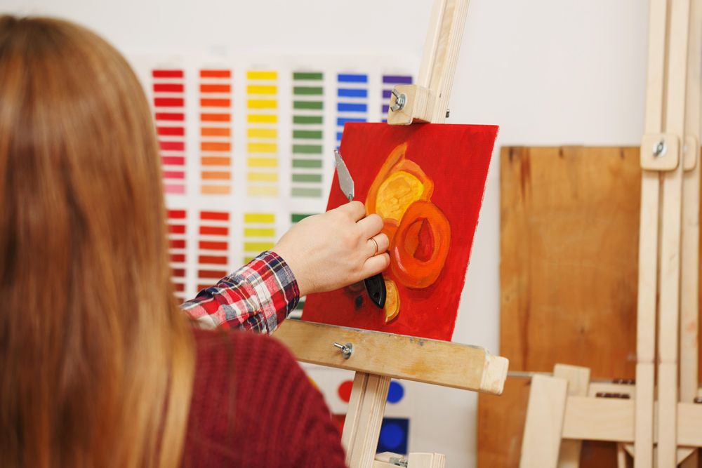 Hand of painter working on image of pastries