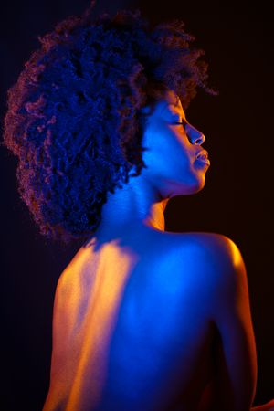 Female with closed eyes in blue gold studio shot