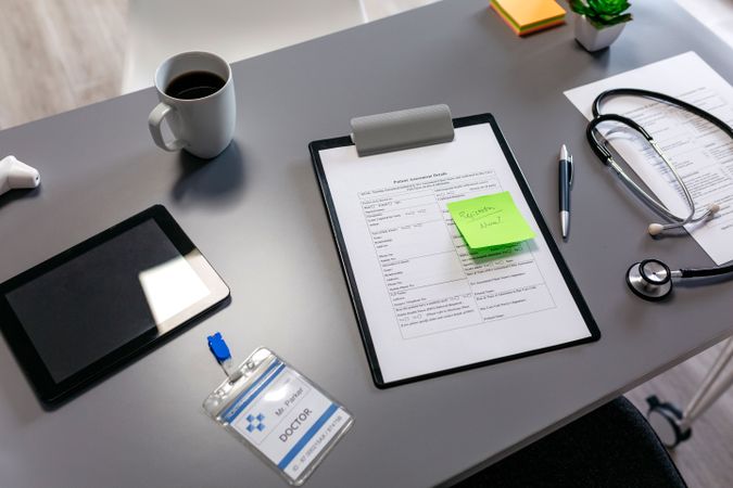 Doctor desk with documents and stethoscope