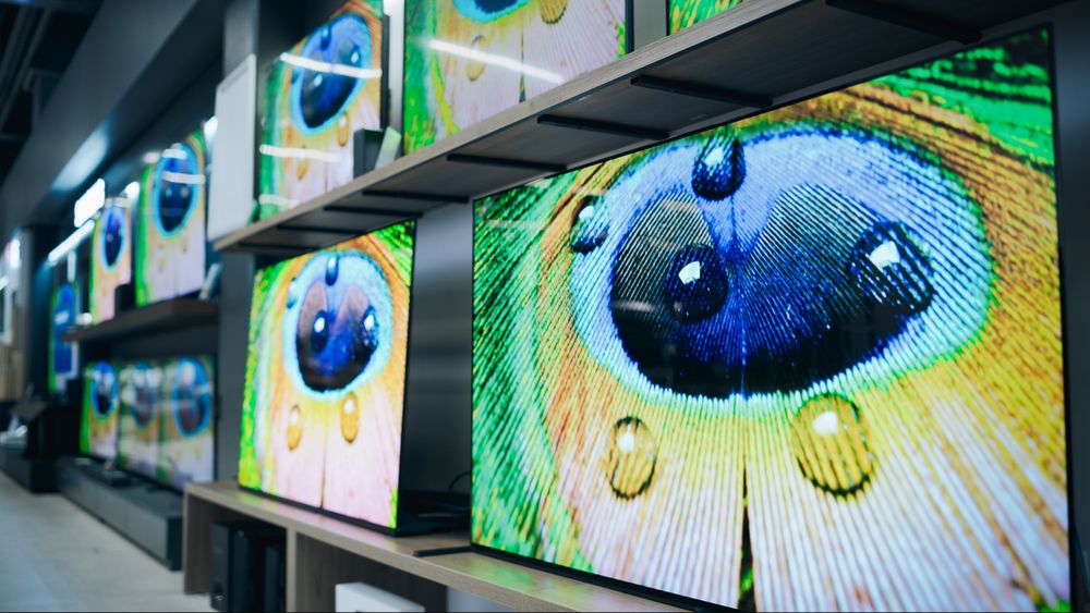 Wide Angle View of Retail Home Electronics Store Displaying Array of Different Modern TVs.