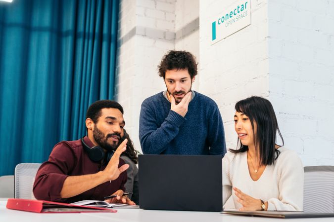 Group of multiracial people working with laptop in a coworking