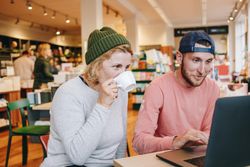 Two colleagues working in a cosy cafe