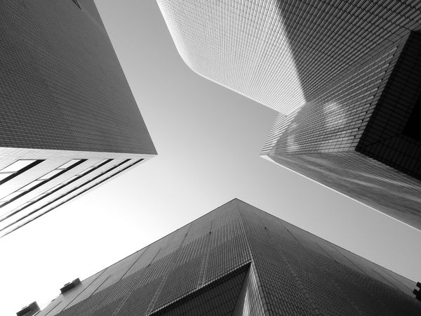 Low angle view of modern buildings in grayscale