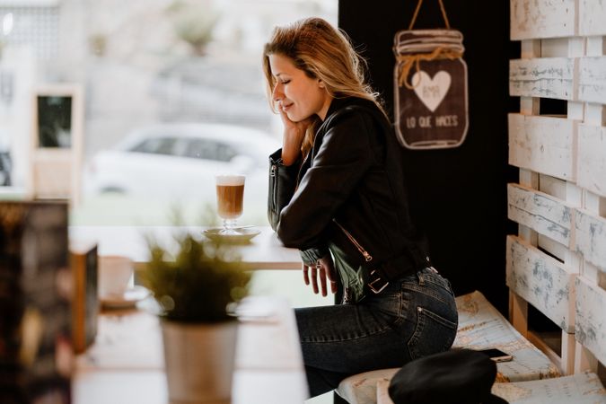 Woman drinking coffee from a glass