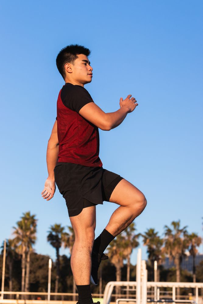 Asian sportsman doing step exercise on street