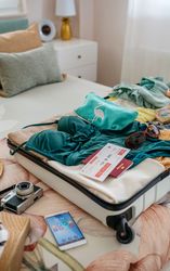 Open woman suitcase prepared for vacation