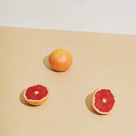 Grapefruit halfs on beige background