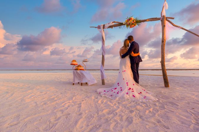 Two people getting married on a tropical beach
