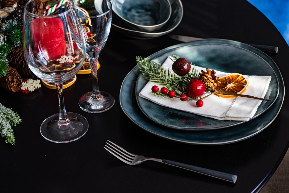 Holiday table setting with decorative berries and dried orange slice