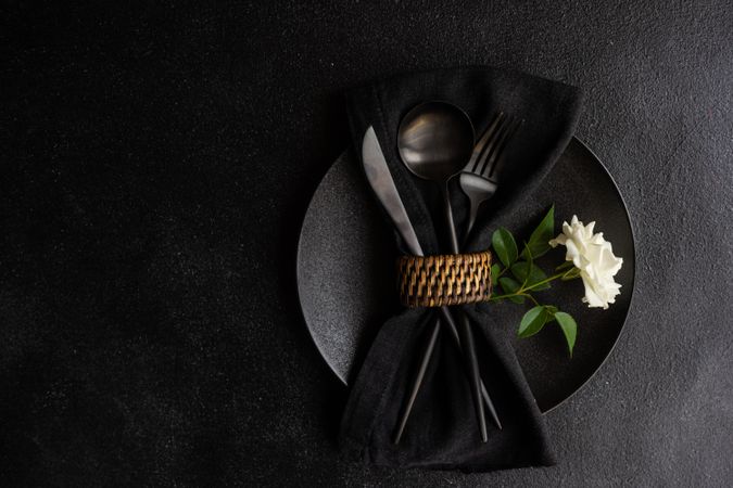 Top view of minimalistic table setting with rose