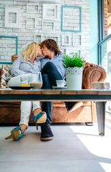 Couple kissing on a sofa