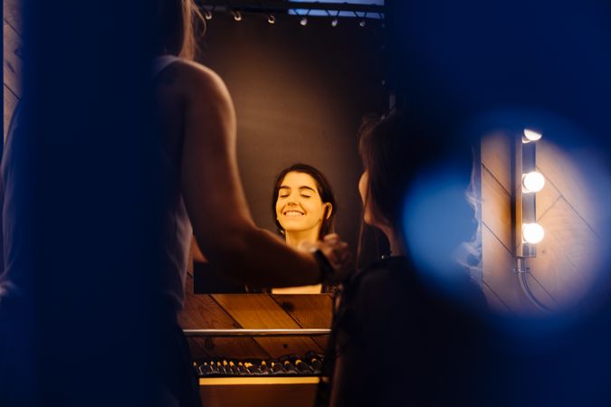 Makeup artist doing makeup for young female artist