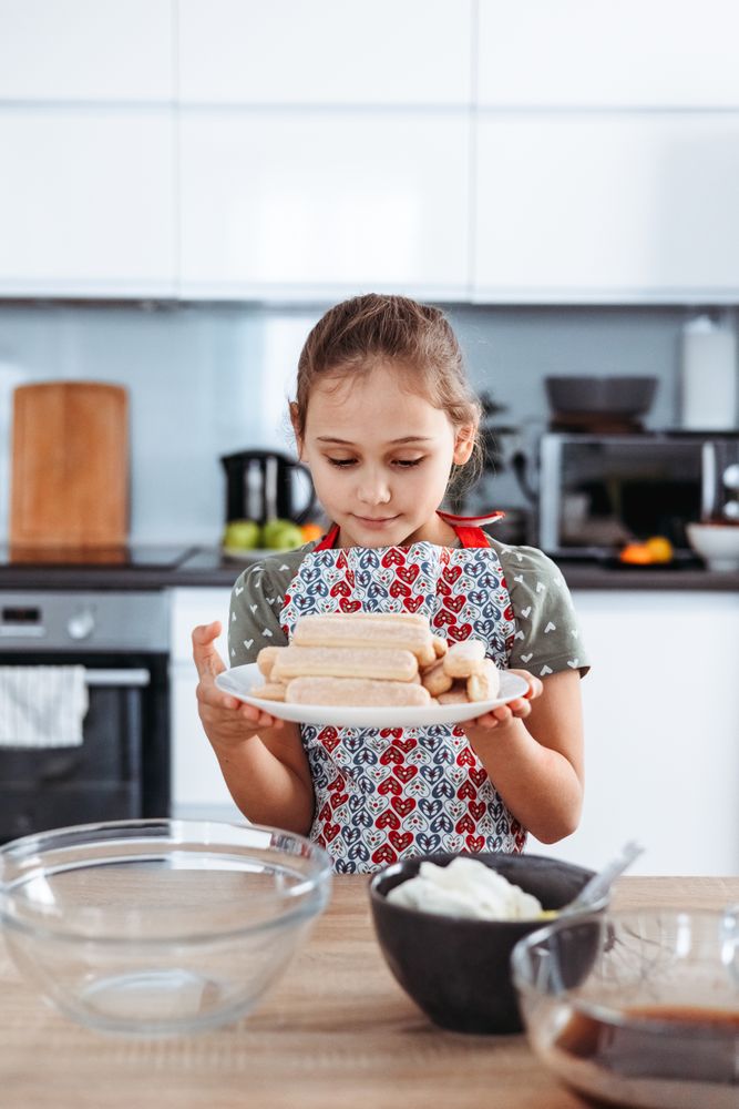 Girl making Italian tiramisu dessert