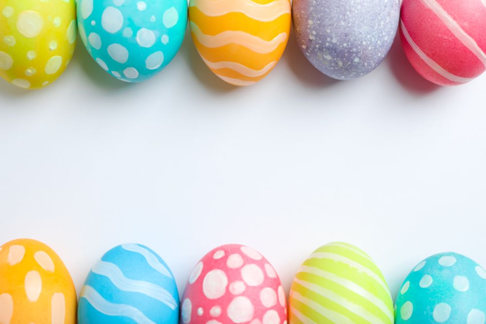 Decorative Easter eggs on neutral background, space for text. Top view