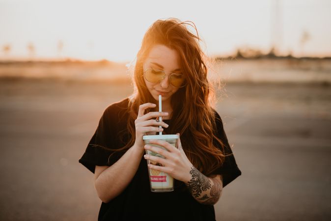 Long haired female drinking milkshake