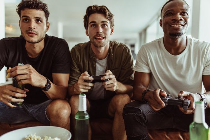 Three friends hanging out and playing video games