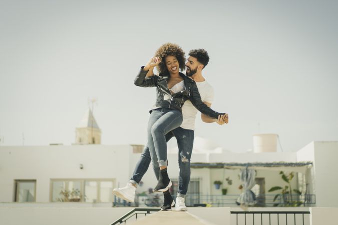 Young couple having fun on street