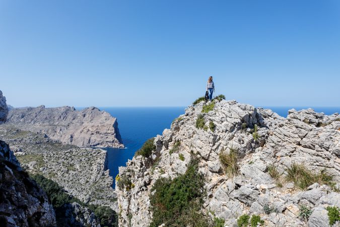 Young woman standing on cliff