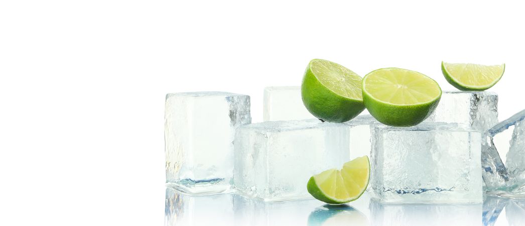 Ice cubes and slices of lime, wide, copy space