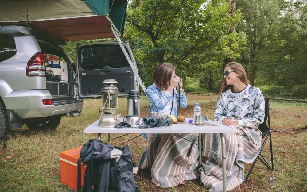 Woman taking photo of friend over breakfast