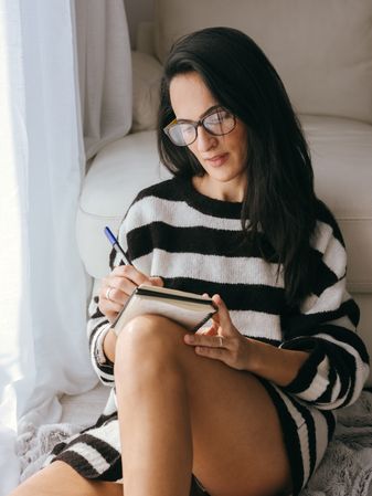 woman writing in planner