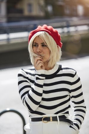 female in red beret outdoors