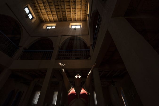 Woman praying in dark church