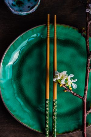 Asian table setting with cherry blossom and chopsticks