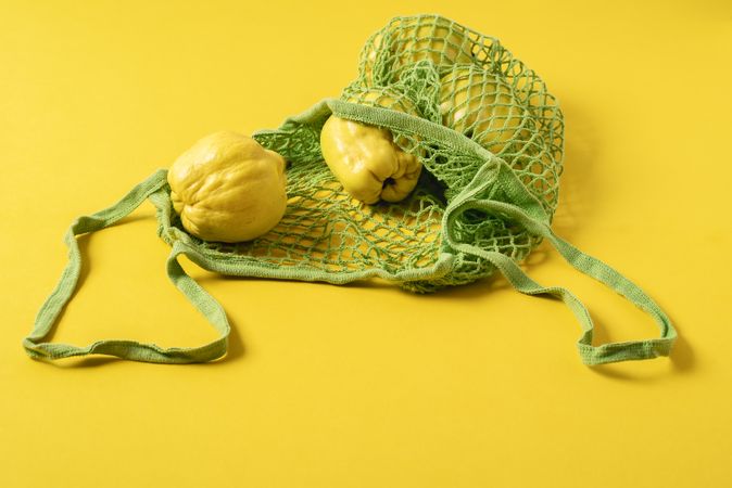 Quince fruits in reusable shopping bag