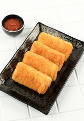 Pile of risol mayo keju, thin crepes rolled with egg and beef inside