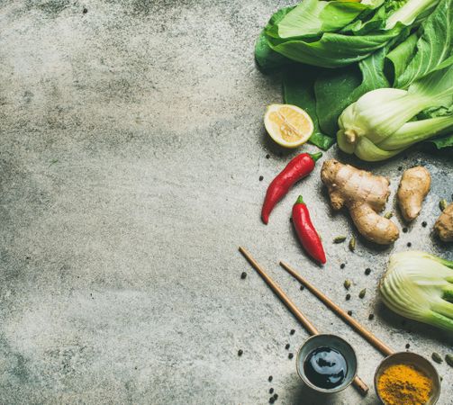 Asian cuisine ingredients over grey background, copy space