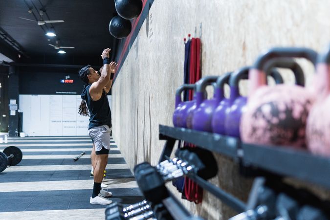 Hispanic sportspeople training with medical balls