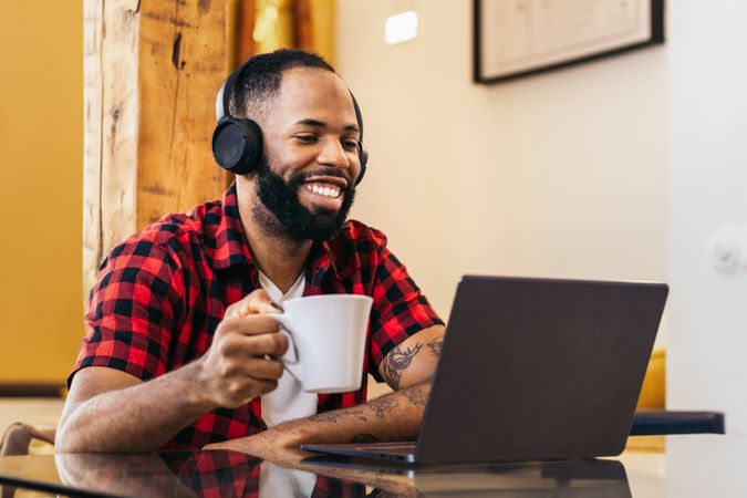 Black man teleworking with laptop from home