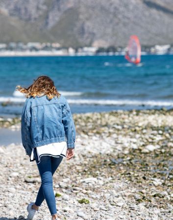 Young woman walking on seashore