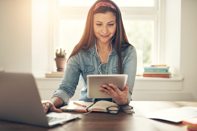 Content woman working on laptop in home office with laptop